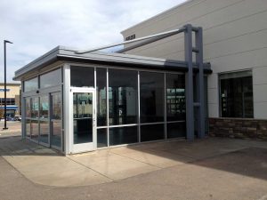 Business entryway with semi dark window film for colling