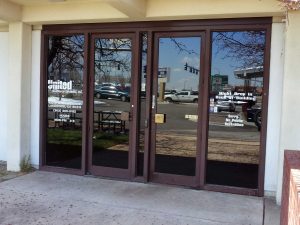 Business with dark window film and graphic signage