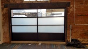Garage door with privacy frost window film